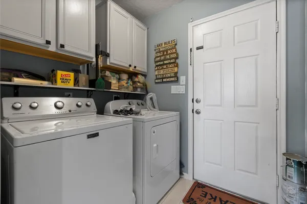 a view of washer and dryer with kitchen view