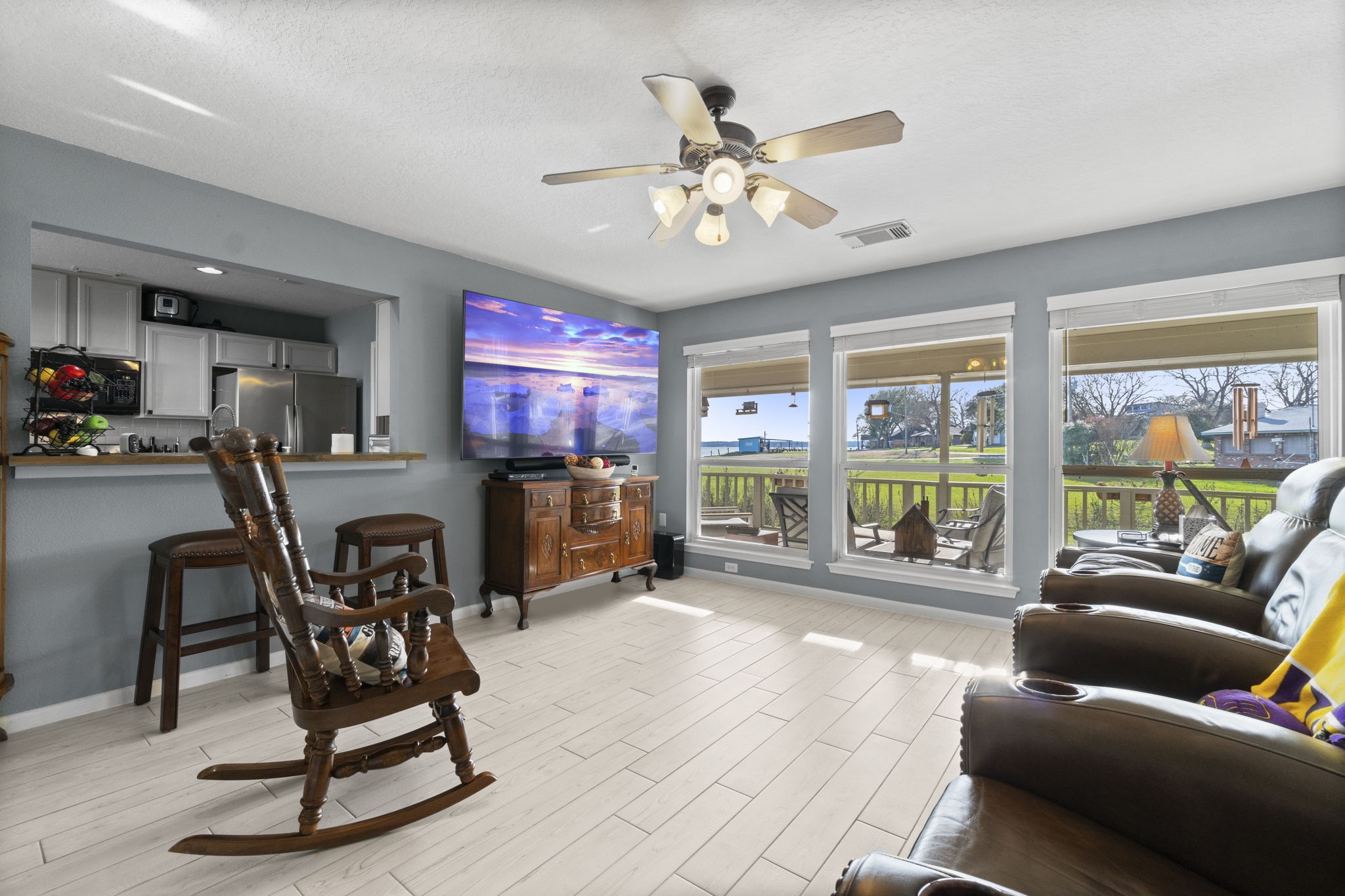 330 Crestmont Point Blank, TX 77364 - Photo 12 of 48 a living room with furniture a floor to ceiling window and a flat screen tv