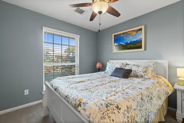 a bedroom with a large bed and a window