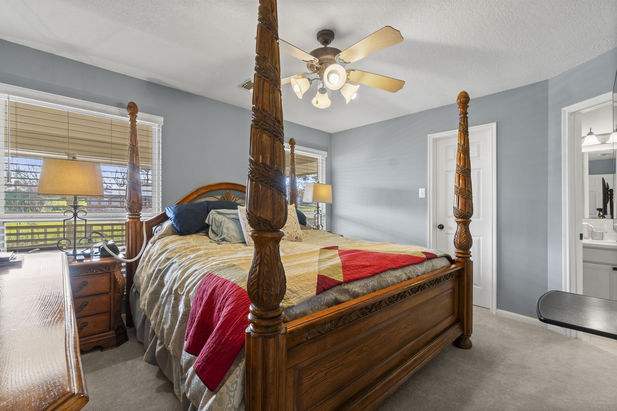 330 Crestmont Point Blank, TX 77364 - Photo 18 of 48 a bedroom with a bed and a chandelier