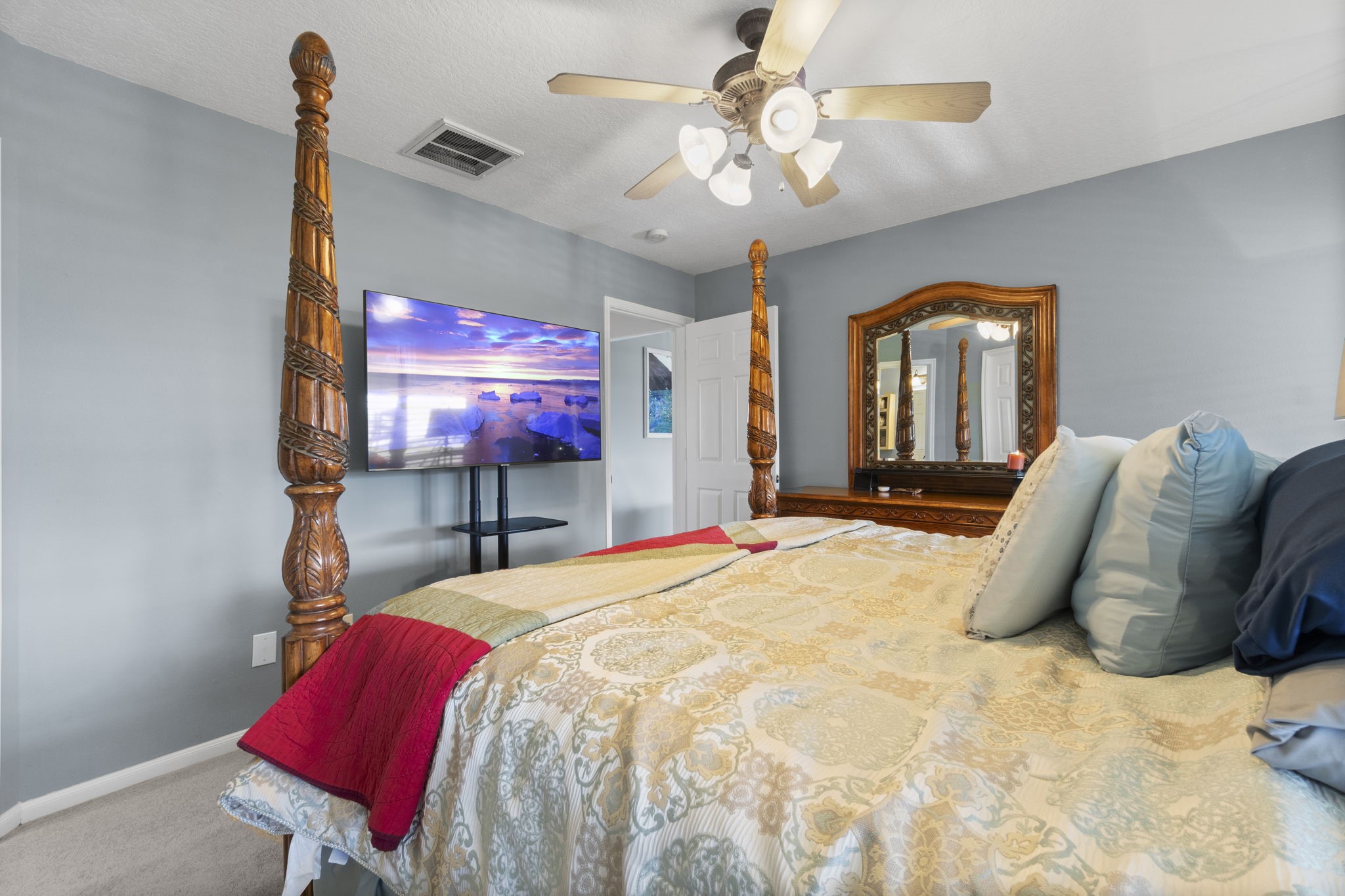 330 Crestmont Point Blank, TX 77364 - Photo 19 of 48 a bedroom with a bed and a chandelier