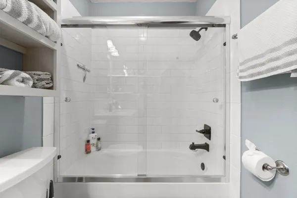 a bathroom with a bathtub and a shower