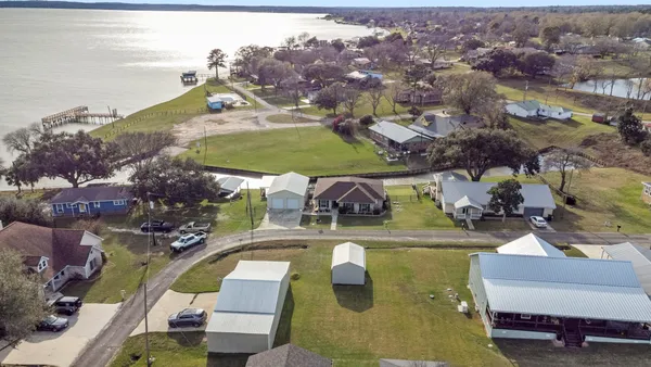 an aerial view of a house with yard swimming pool and outdoor seating