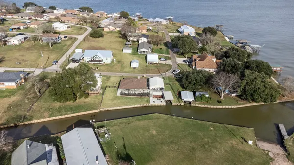 an aerial view of a house with a swimming pool