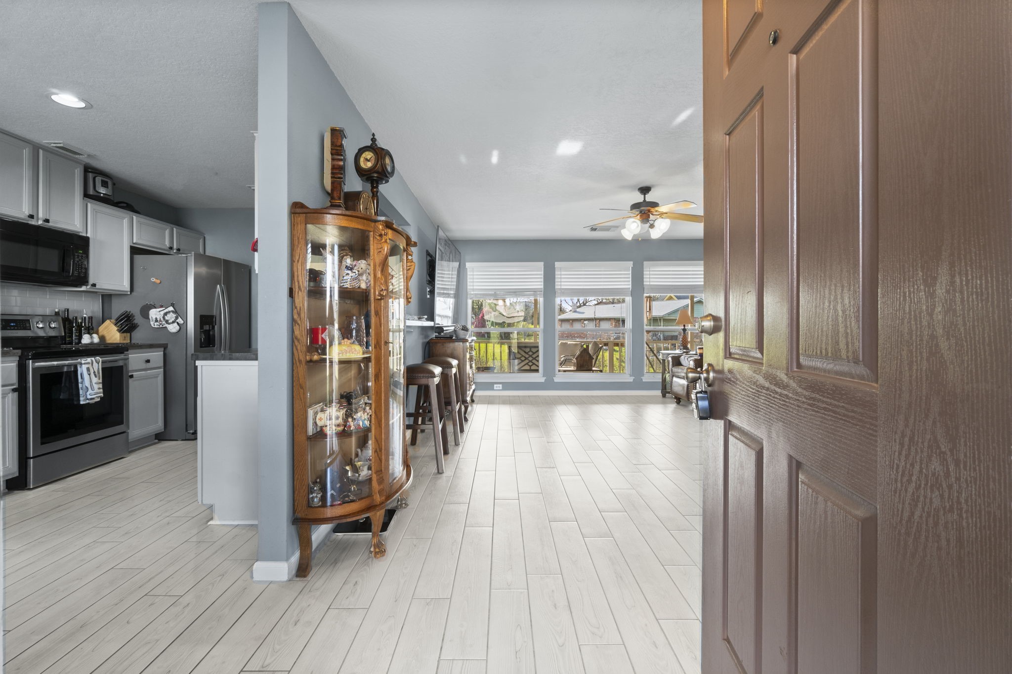 330 Crestmont Point Blank, TX 77364 - Photo 5 of 48 a view of a living room and a kitchen with furniture wooden floor and a window