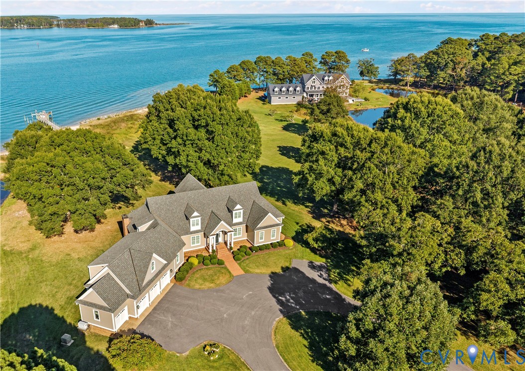 an aerial view of a house with a ocean view