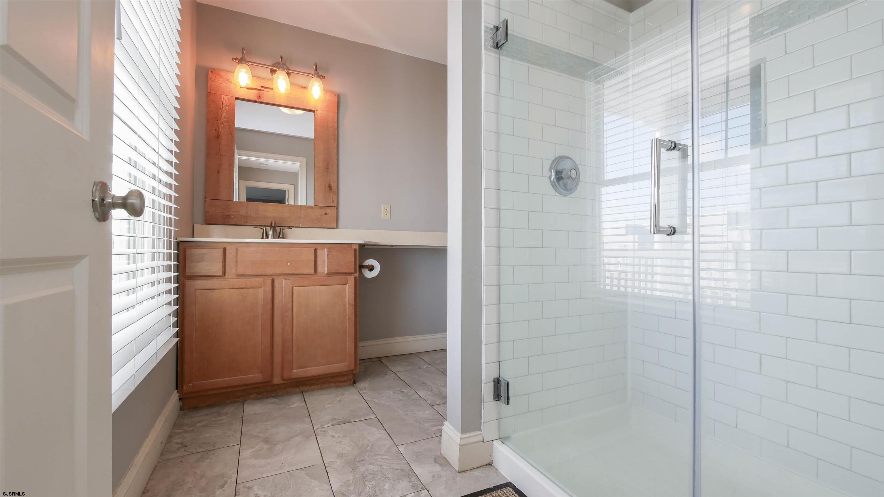 2070 West Riverside Drive Atlantic City, NJ 08401 - Photo 26 of 40 a bathroom with a sink a toilet and shower