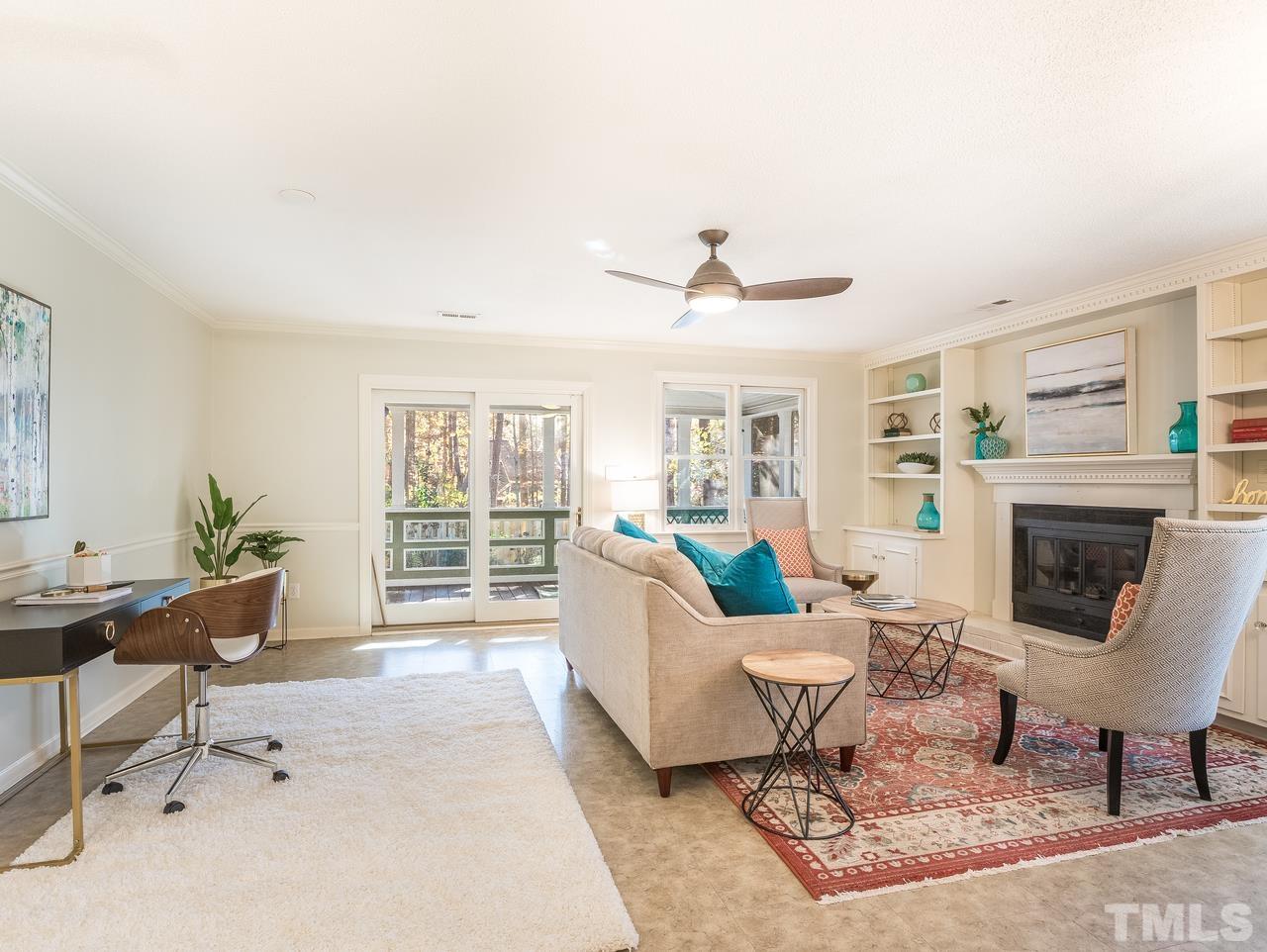 1507 Edgeside Court Raleigh, NC 27609 - Photo 4 of 28 a living room with furniture a fireplace and a table