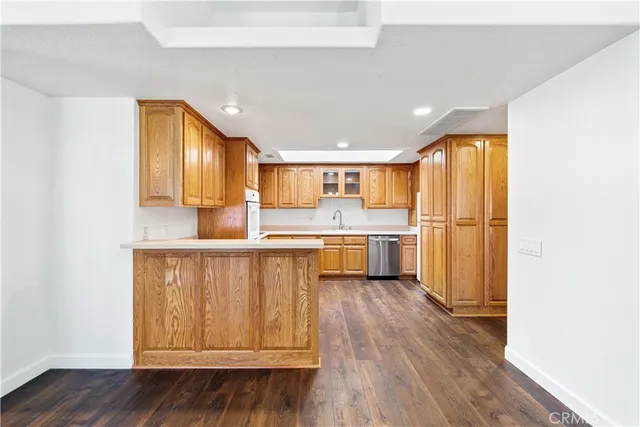 a kitchen with a refrigerator a sink and cabinets