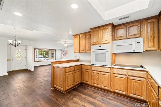 a kitchen with stainless steel appliances granite countertop a sink stove and wooden cabinets