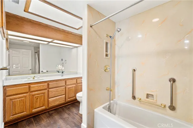 a bathroom with a tub sink and mirror