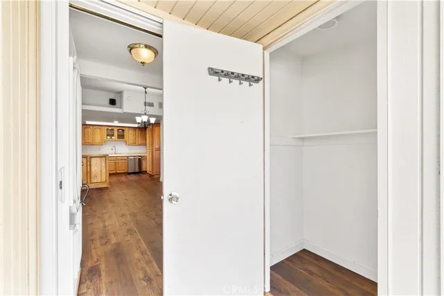 a view of walk in closet with wooden floor