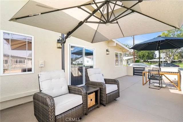 a outdoor living space with furniture and umbrella