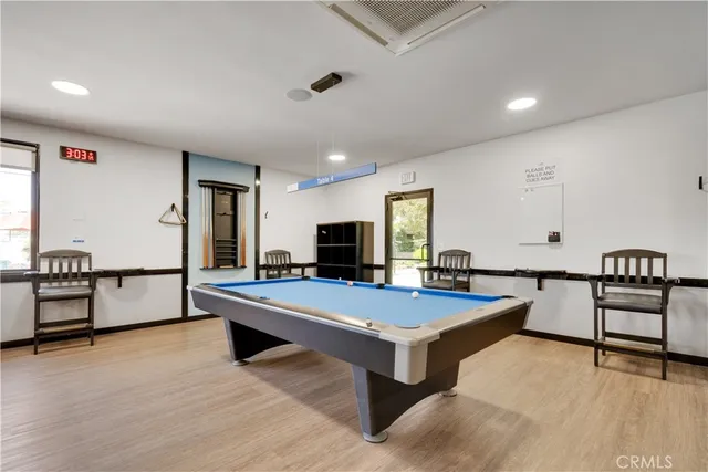 a room with pool table and flat screen tv