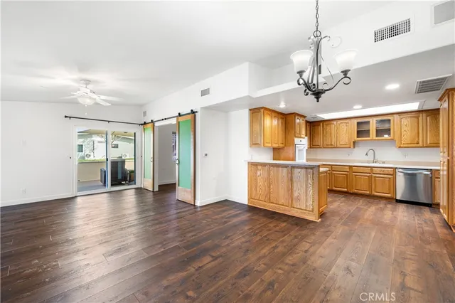 a view of a kitchen with a sink stainless steel appliances and cabinets
