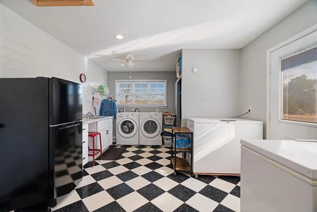 a kitchen with a stove a refrigerator and a stove top oven