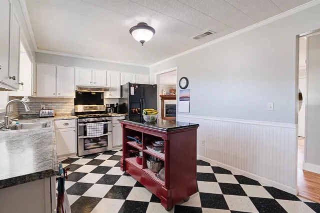 a kitchen with stainless steel appliances and cabinets