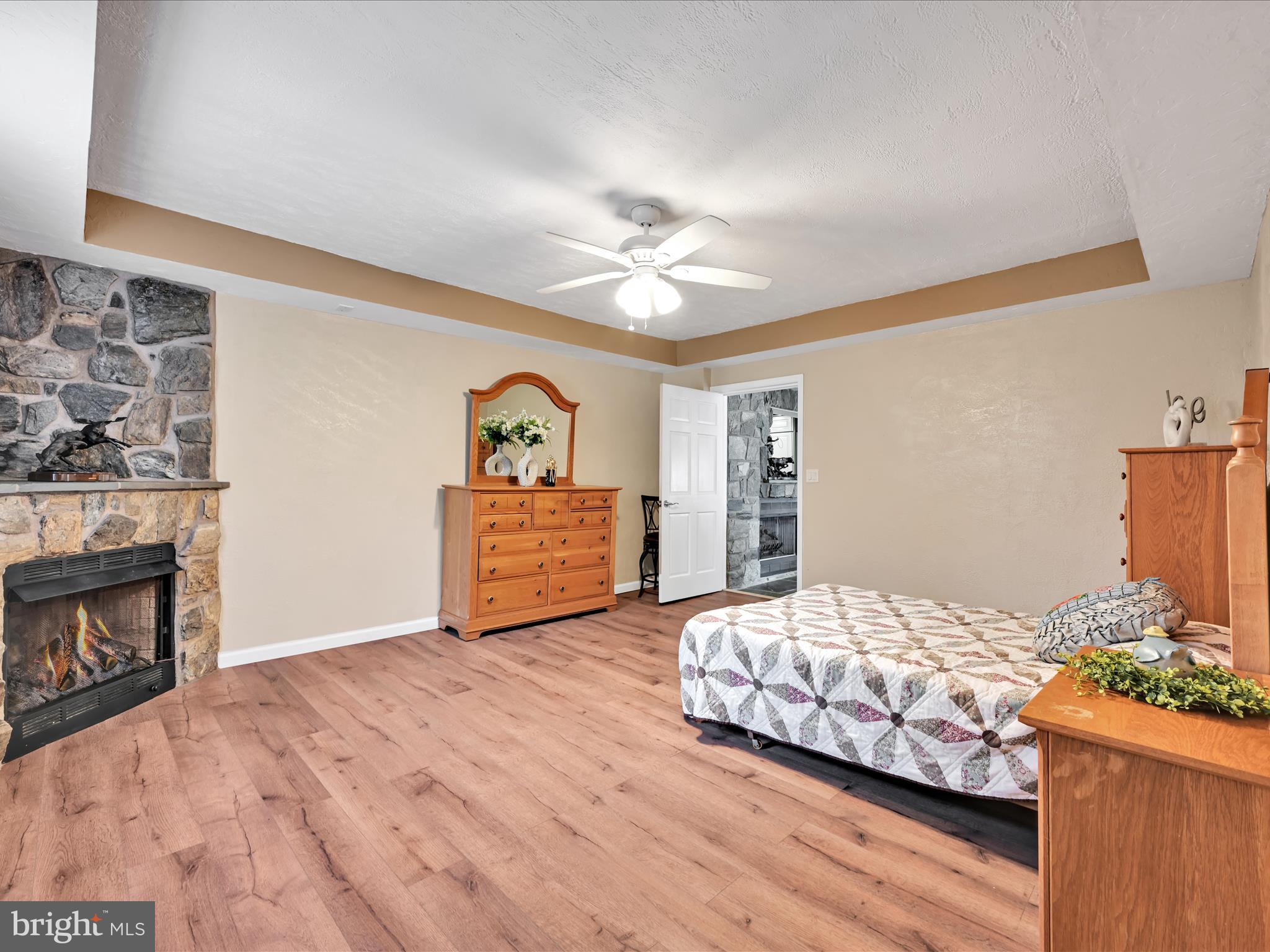 742 Power Road Manheim, PA 17545 - Photo 22 of 56 a bedroom with a bed and a fireplace