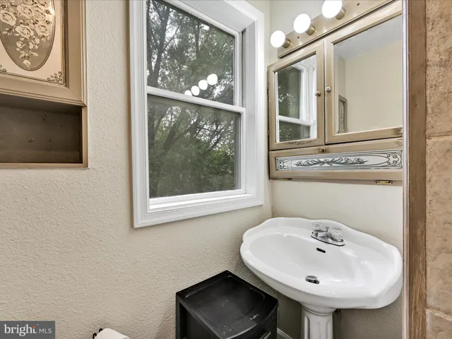 a bed sitting in a spacious bedroom next to a window