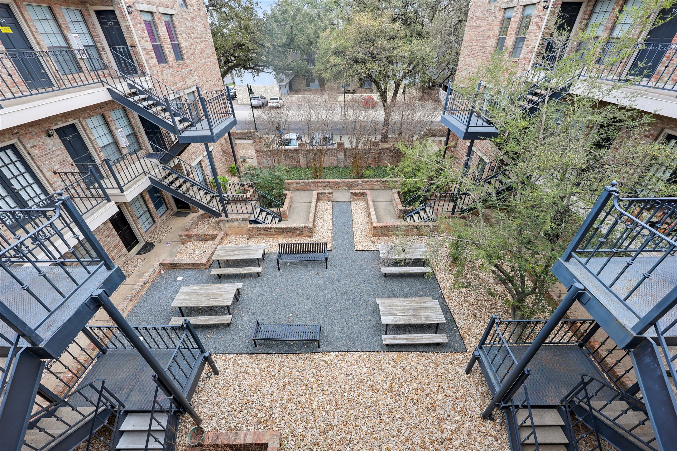 2801 Rio Grande Street, Unit 103 Austin, TX 78705 - Photo 14 of 15 a view of a patio with couches table and chairs and potted plants