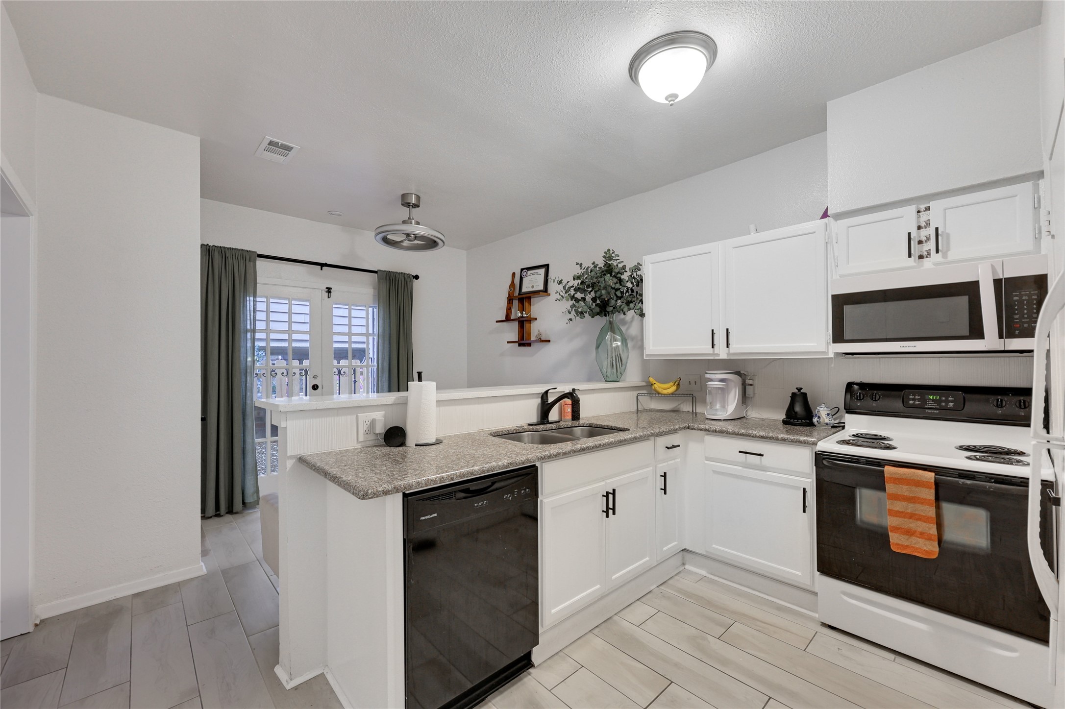2801 Rio Grande Street, Unit 103 Austin, TX 78705 - Photo 3 of 15 a kitchen with stainless steel appliances granite countertop a sink and stove top oven