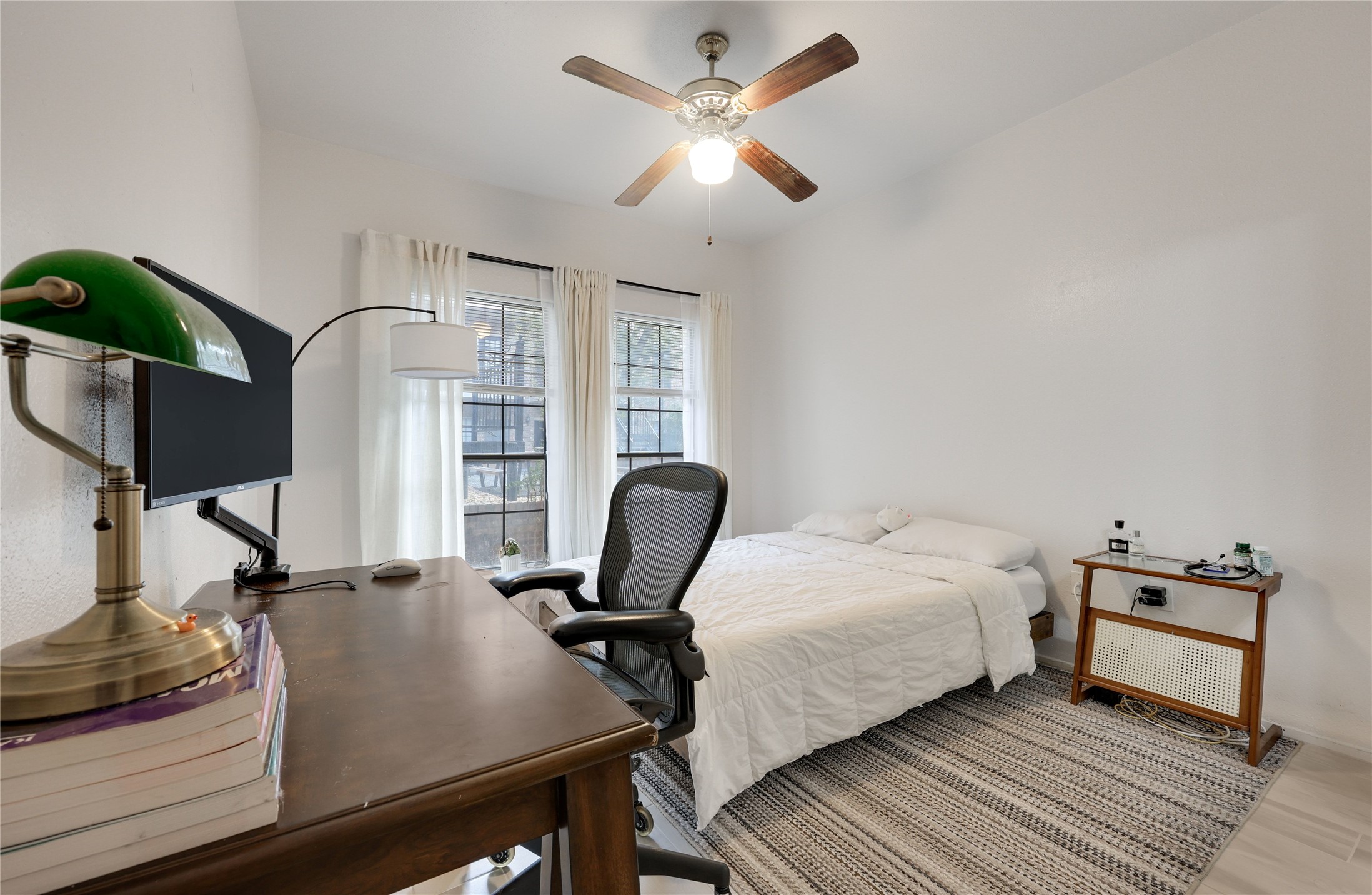 2801 Rio Grande Street, Unit 103 Austin, TX 78705 - Photo 6 of 15 a bedroom with a bed and wooden floor