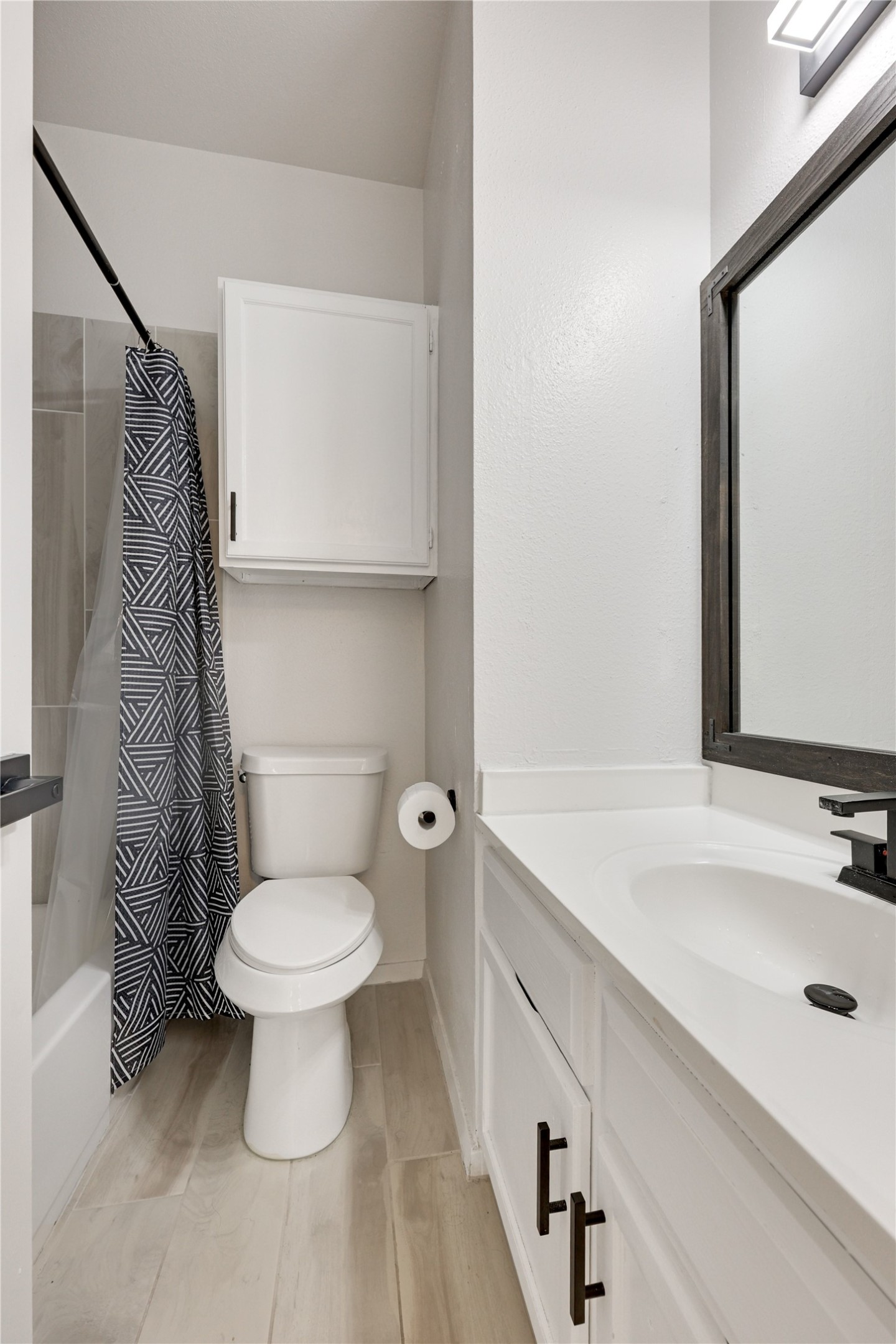 2801 Rio Grande Street, Unit 103 Austin, TX 78705 - Photo 7 of 15 a bathroom with a sink and a mirror