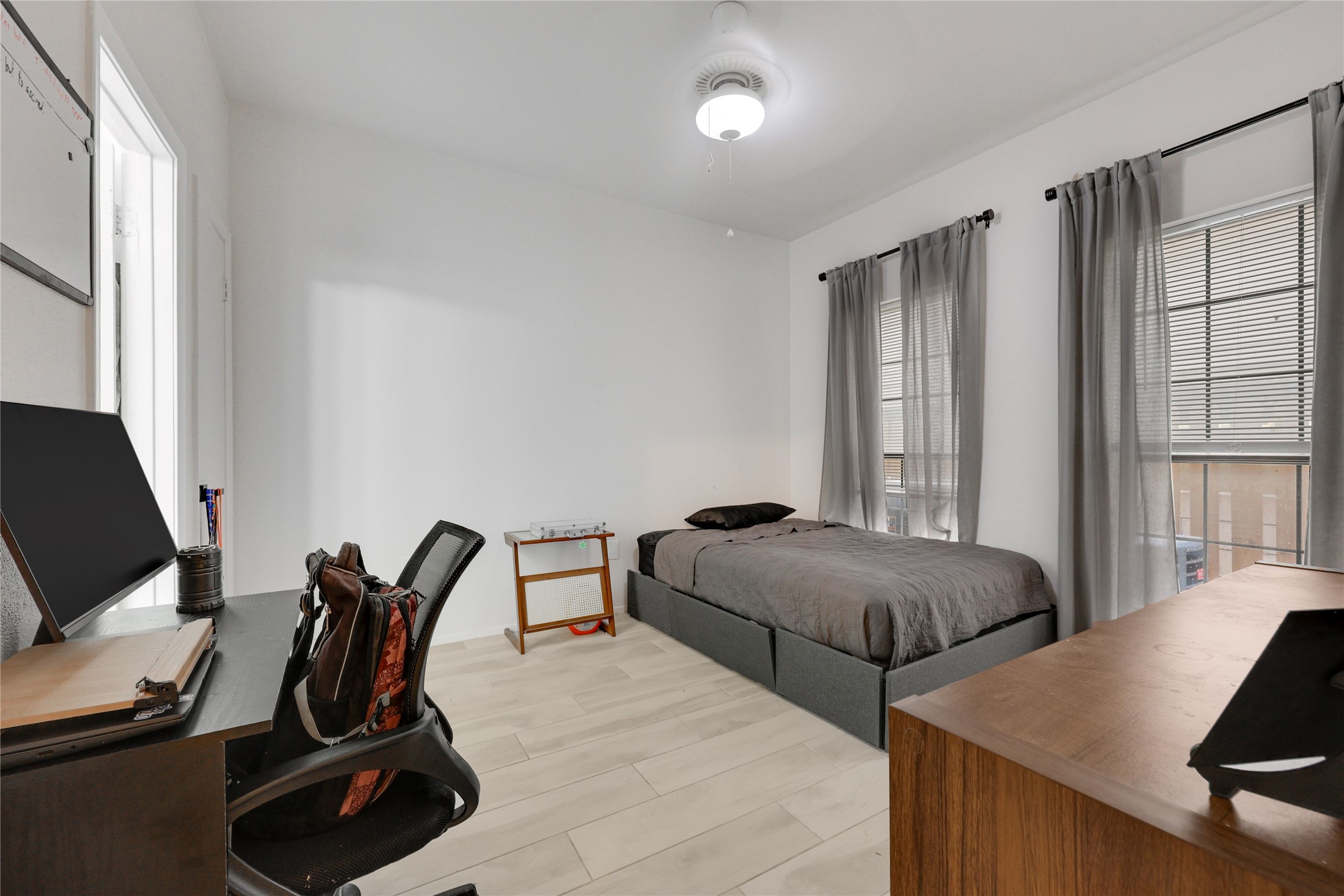 2801 Rio Grande Street, Unit 103 Austin, TX 78705 - Photo 8 of 15 a bedroom with two beds and a window