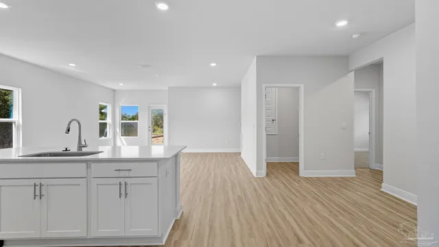 a kitchen with stainless steel appliances granite countertop a sink and stove top oven