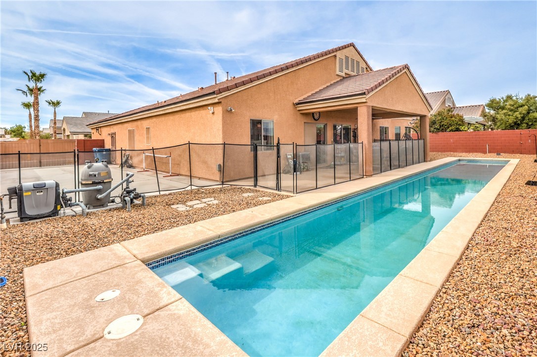 View of swimming pool featuring a fenced backyard, a patio, and a fenced in pool