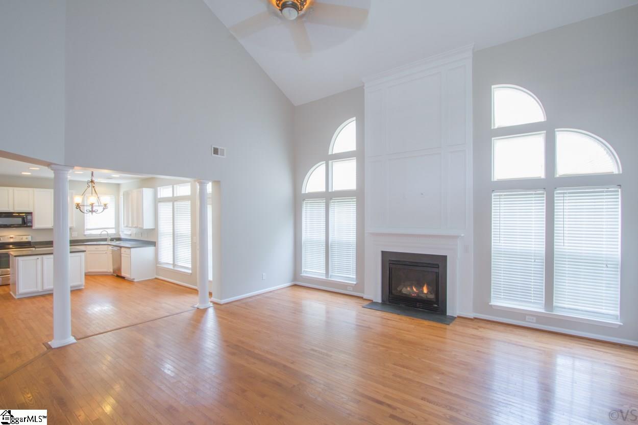 105 Selden Way Fountain Inn, SC 29644 - Photo 7 of 31 Gorgeous Family Room with vaulted ceilings. Check out that fireplace and the large beautiful windows surrounding it! Hardwood floors and new paint. Great open concept so all your time with family is spent together, even when in the kitchen.