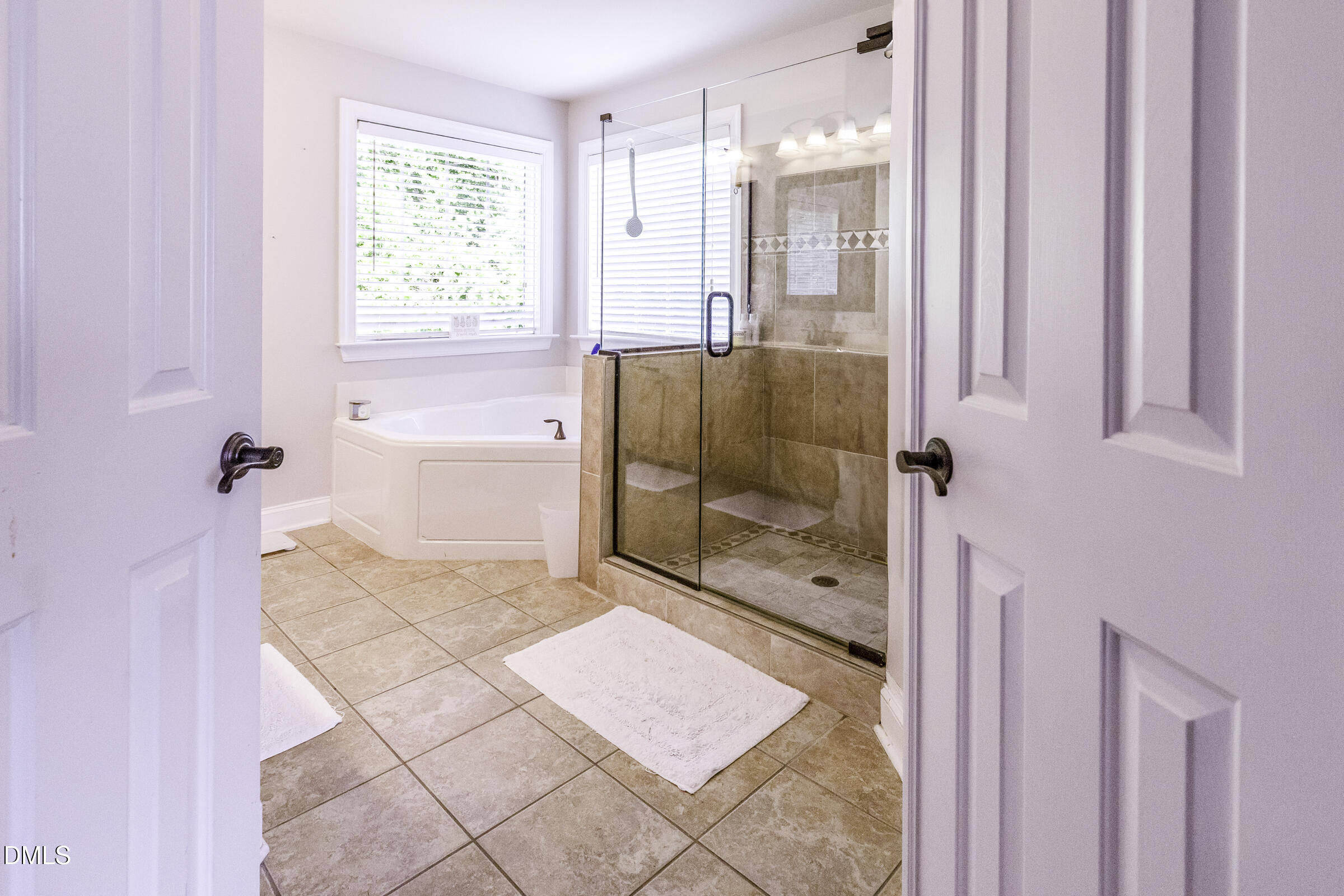 201 Quarryrock Road Holly Springs, NC 27540 - Photo 27 of 34 a bathroom with a glass shower door and a window
