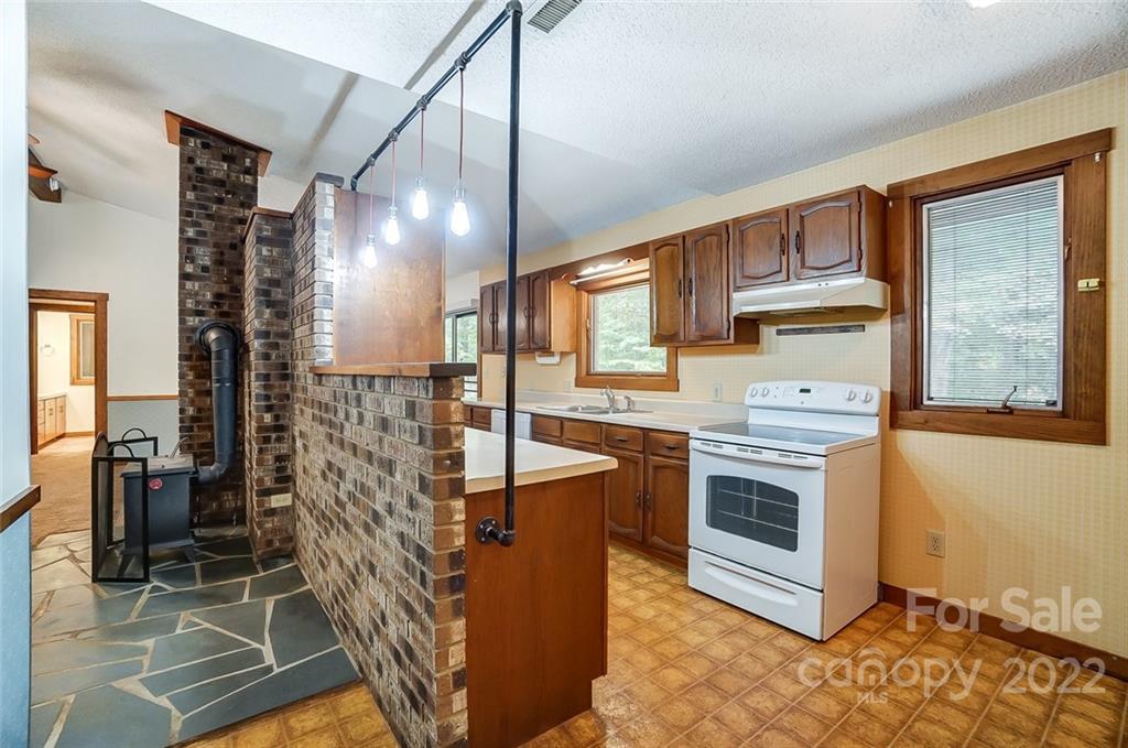 5618 Davis Road Waxhaw, NC 28173 - Photo 12 of 41 a kitchen with stainless steel appliances granite countertop a stove a sink and a refrigerator