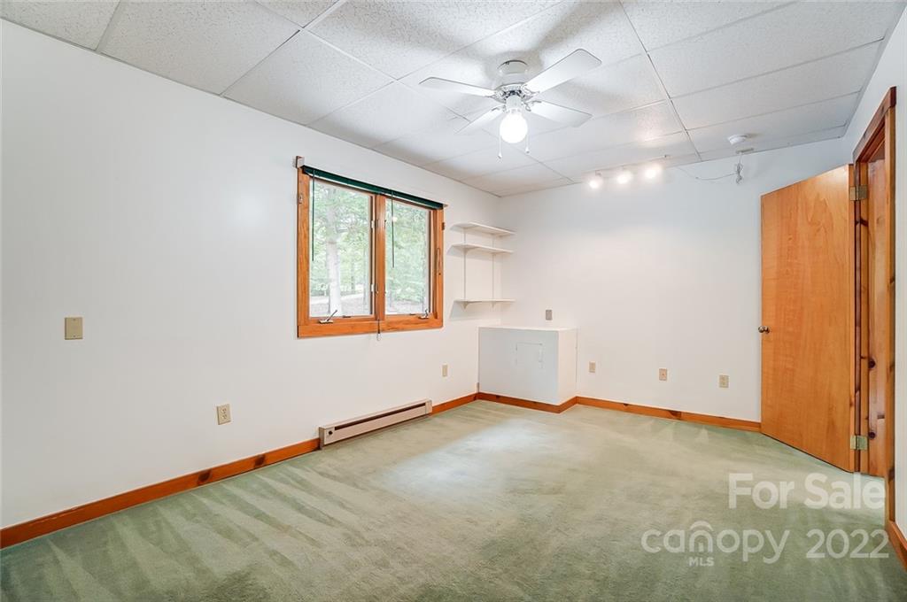 5618 Davis Road Waxhaw, NC 28173 - Photo 15 of 41 an empty room with chandelier fan and windows