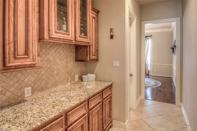 a kitchen with kitchen island granite countertop a sink stove and cabinets