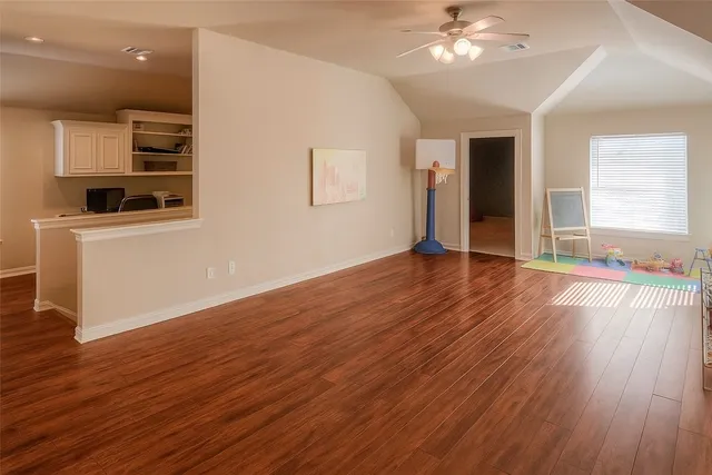 a room with furniture and a chandelier fan