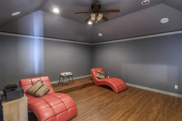 a spacious bedroom with a bed a table chair and a chandelier