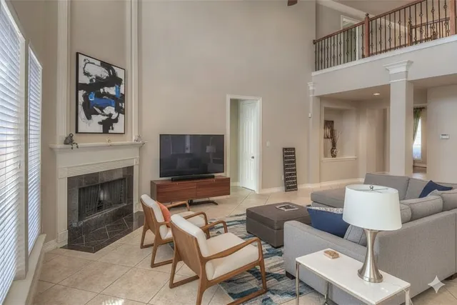 a living room with furniture a fireplace and a flat screen tv
