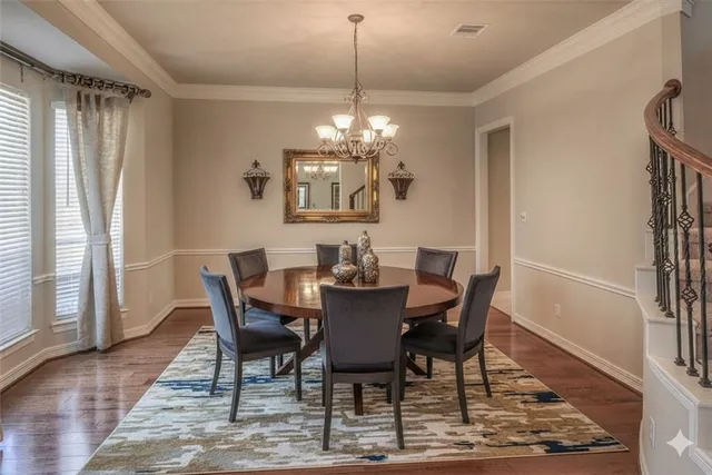a view of a dining room with furniture and a chandelier