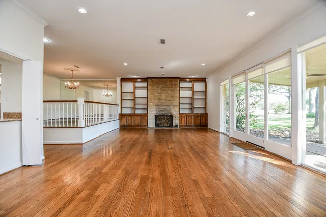 a view of a room with wooden floor and fence