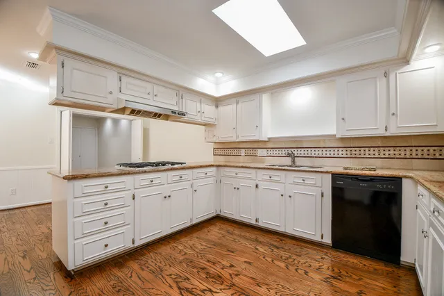 a kitchen with granite countertop white cabinets and white appliances