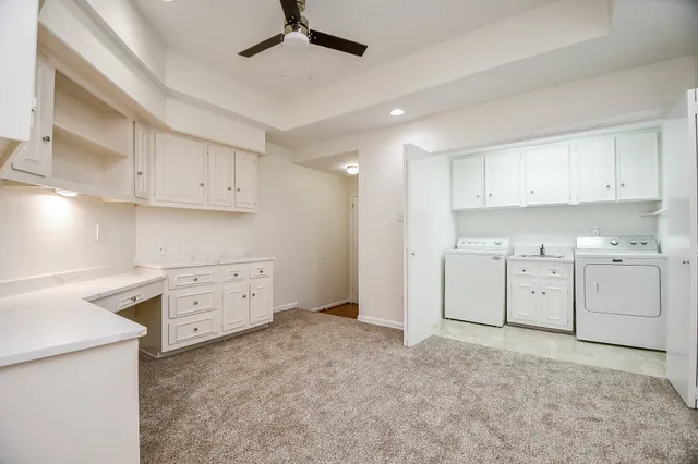 a kitchen with cabinets stainless steel appliances and a window