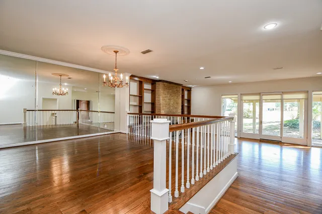 a view of a room wooden floor and windows