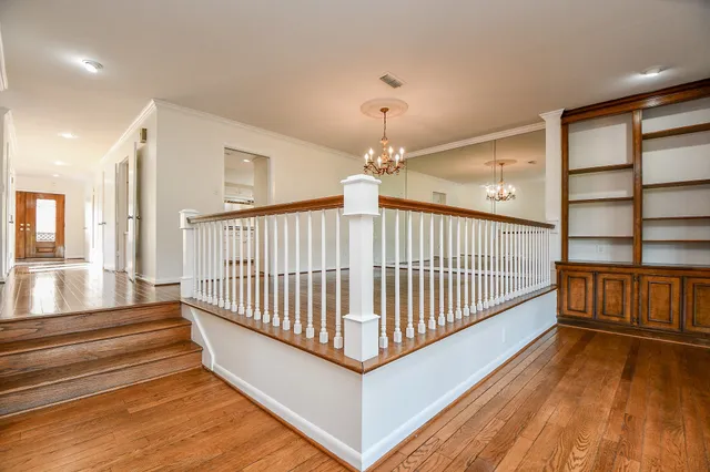 a view of staircase with wooden floor and a window