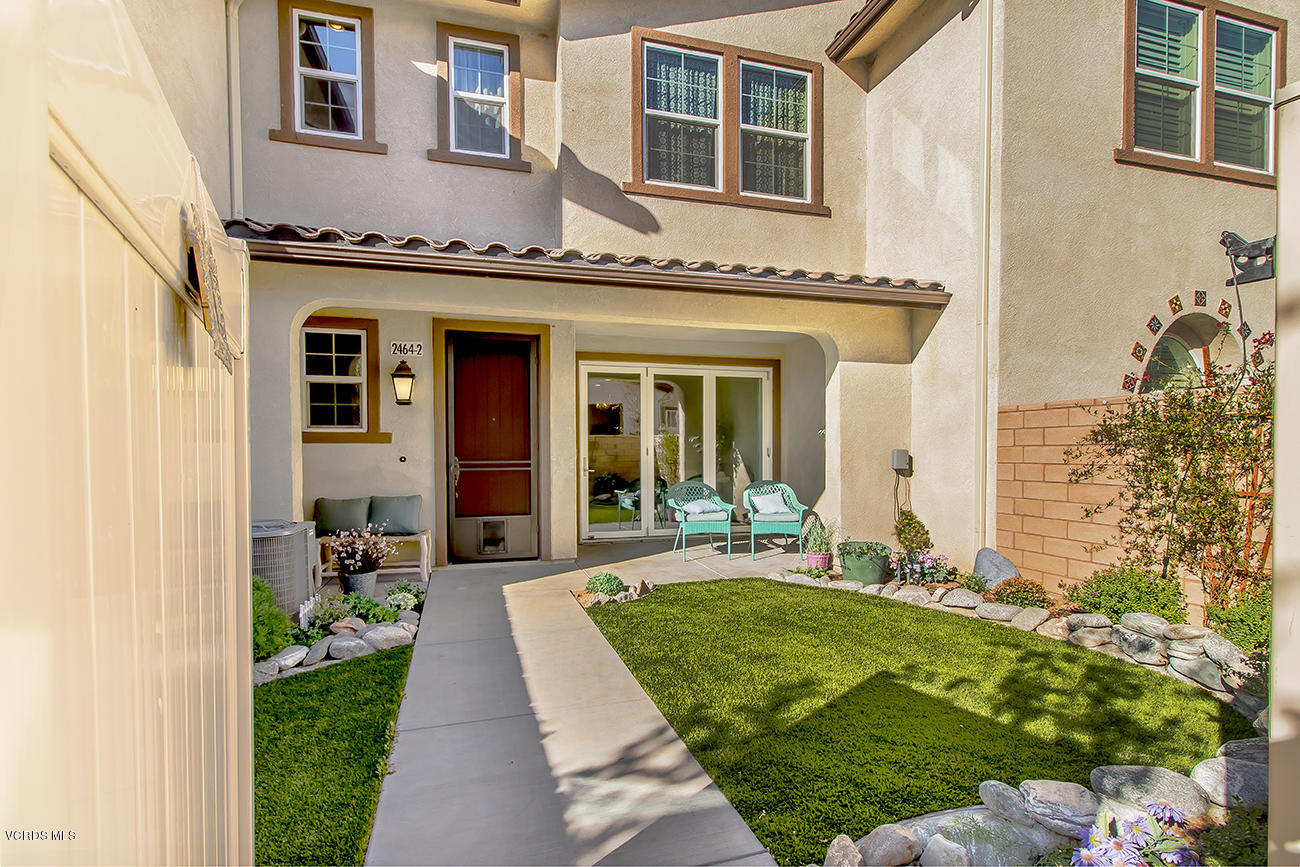2464 Blossom Ridge Court, Unit 2 Simi Valley, CA 93063 - Photo 1 of 41 a front view of a house with a yard