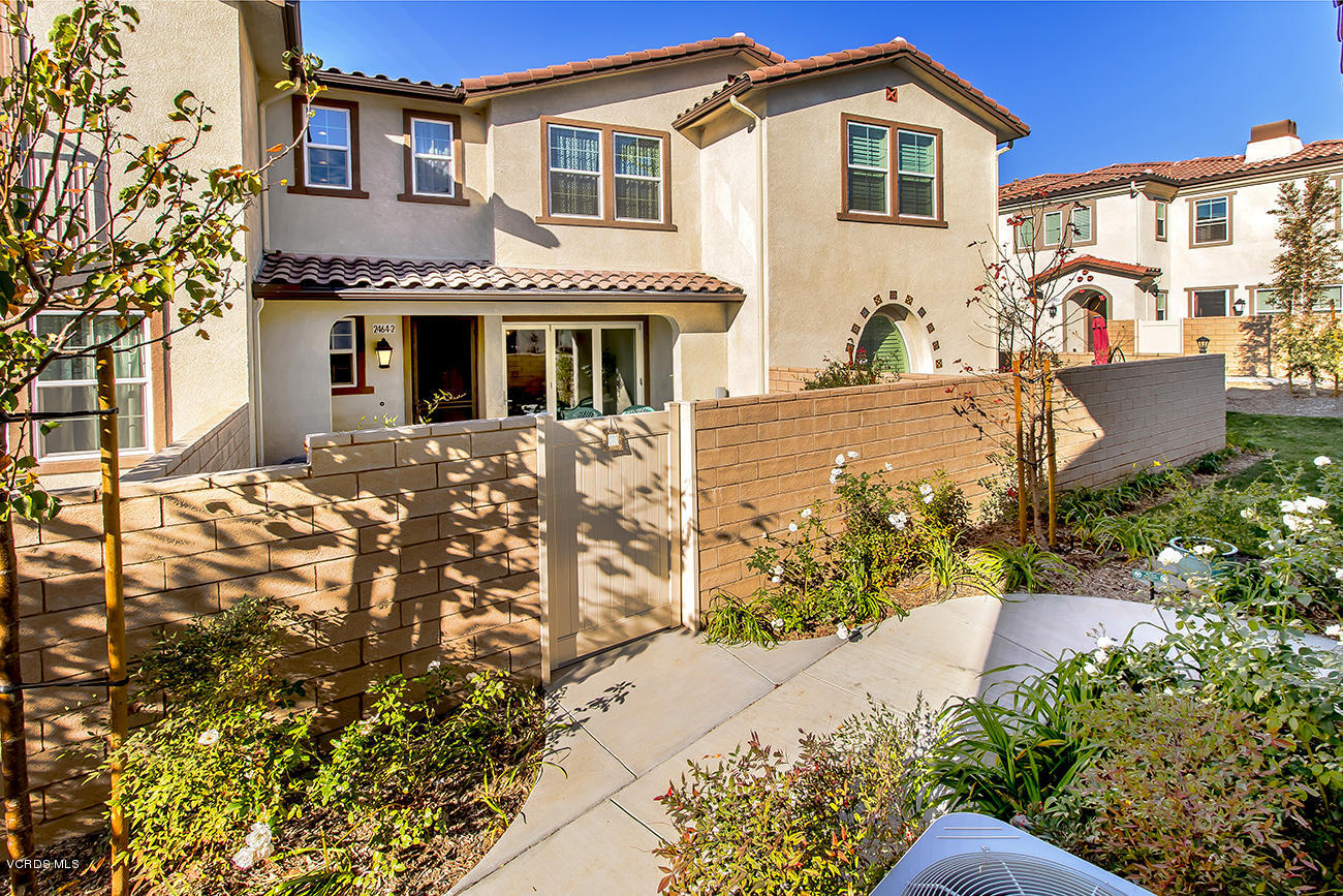 2464 Blossom Ridge Court, Unit 2 Simi Valley, CA 93063 - Photo 2 of 41 a front view of a house with a yard