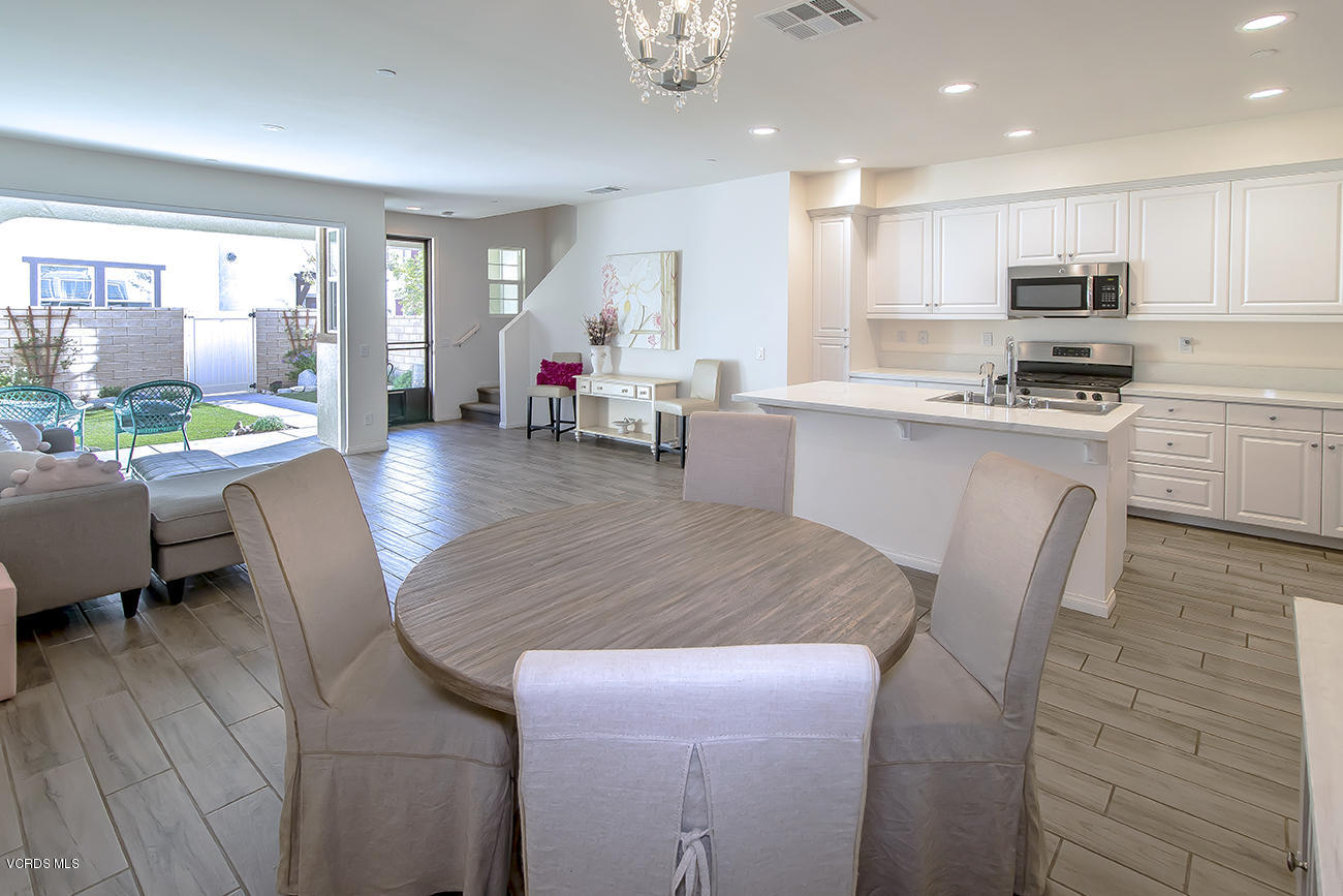 2464 Blossom Ridge Court, Unit 2 Simi Valley, CA 93063 - Photo 11 of 41 a kitchen with sink a refrigerator and chairs