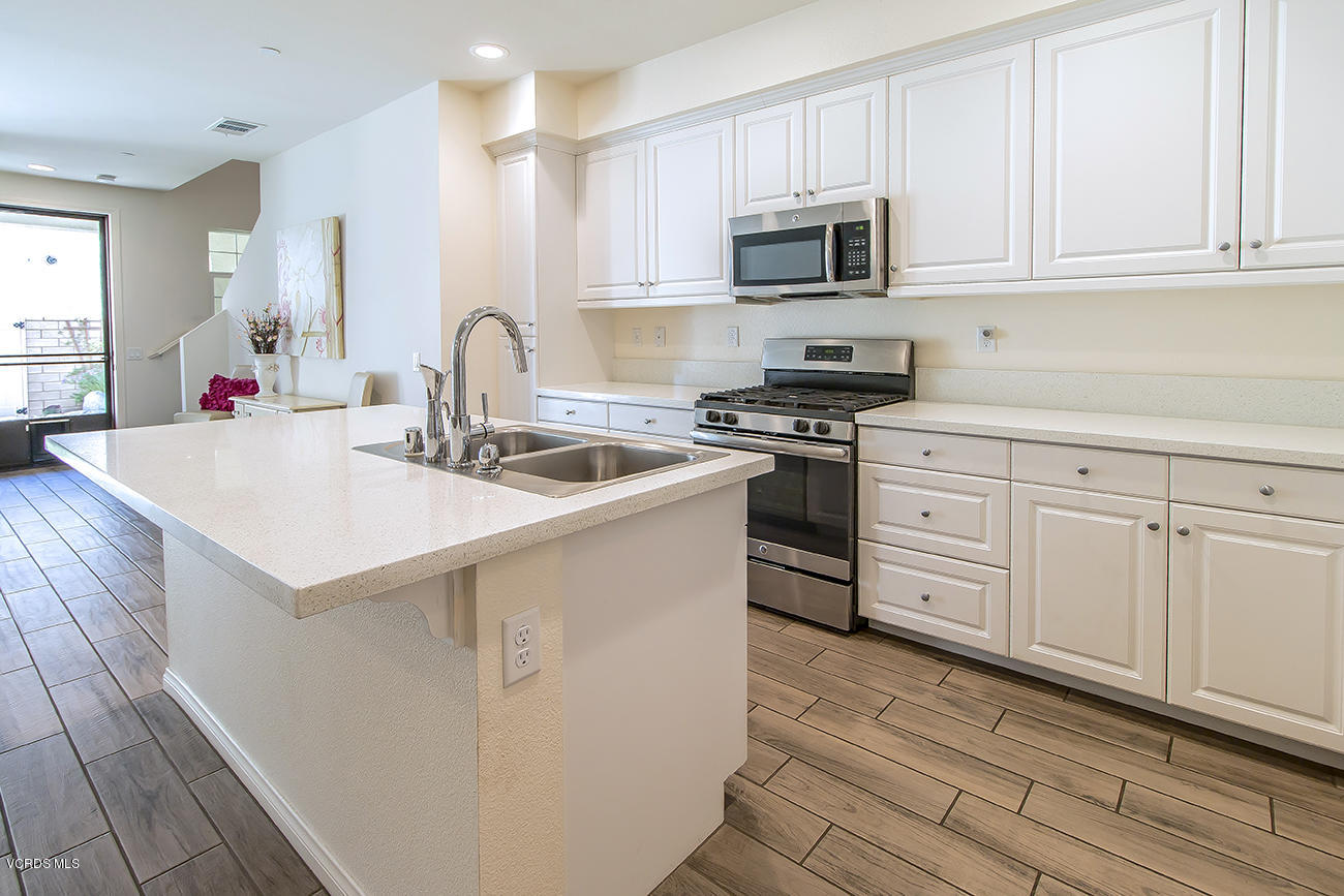 2464 Blossom Ridge Court, Unit 2 Simi Valley, CA 93063 - Photo 15 of 41 a kitchen with granite countertop white cabinets and stainless steel appliances
