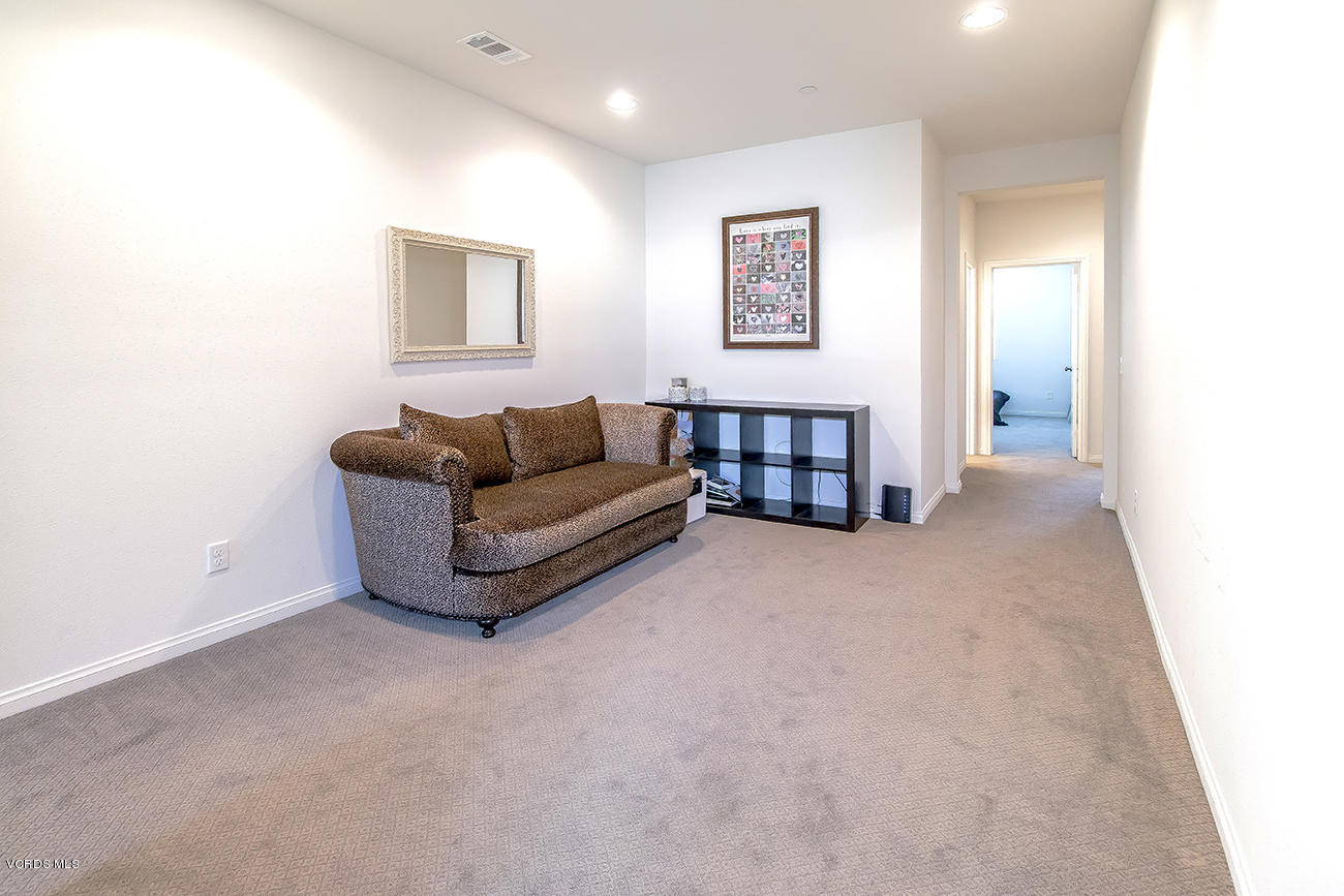2464 Blossom Ridge Court, Unit 2 Simi Valley, CA 93063 - Photo 17 of 41 a living room with furniture and a wall painting