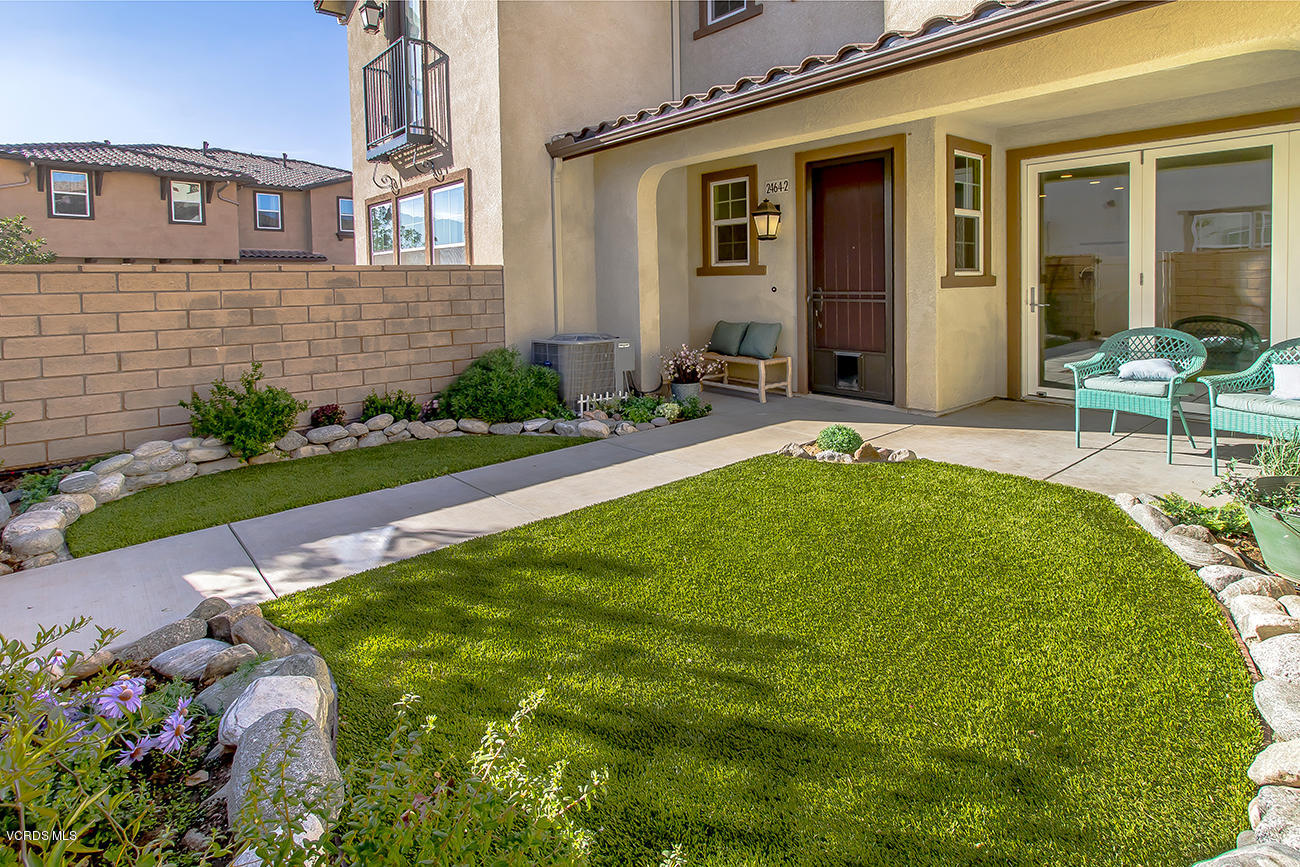 2464 Blossom Ridge Court, Unit 2 Simi Valley, CA 93063 - Photo 3 of 41 a front view of a house with garden